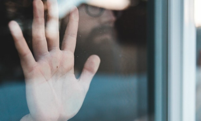 Hand against glass web 2000x900